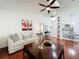 Bright living room with hardwood floors, comfortable sofas, and a stylish ceiling fan at 6559 Grosvenor Ln, Orlando, FL 32835
