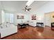 Spacious living room boasts hardwood floors, natural light, and comfortable seating at 6559 Grosvenor Ln, Orlando, FL 32835