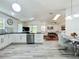 Open concept design kitchen with granite counters, leading into the living room with lots of natural light at 6559 Grosvenor Ln, Orlando, FL 32835