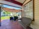 Covered patio with a comfortable seating area with a view of the backyard at 6559 Grosvenor Ln, Orlando, FL 32835