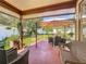 Covered patio with outdoor dining area and view of the landscaped backyard at 6559 Grosvenor Ln, Orlando, FL 32835