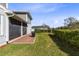 This backyard features green grass, a brick paver patio, and tasteful landscaping at 6665 Bridgman St, Orlando, FL 32827