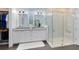 Bright bathroom featuring a glass shower, double vanity and spacious walk-in closet at 6665 Bridgman St, Orlando, FL 32827