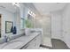 Bright bathroom featuring double vanity sinks, a glass-enclosed shower, and contemporary fixtures at 6665 Bridgman St, Orlando, FL 32827