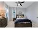 This cozy bedroom features a wood bed frame, neutral paint and bedside table at 6665 Bridgman St, Orlando, FL 32827