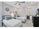 Bright bedroom featuring two twin beds, stylish decor, and vanity area at 6665 Bridgman St, Orlando, FL 32827
