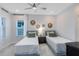 Inviting bedroom featuring two twin beds, stylish decor, and a comfortable atmosphere at 6665 Bridgman St, Orlando, FL 32827