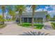 Stylish community clubhouse featuring modern architecture, landscaping, and palm trees at 6665 Bridgman St, Orlando, FL 32827