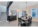 Elegant dining area with contemporary chandelier, stylish dark wood furniture, and seamless flow into the adjoining spaces at 6665 Bridgman St, Orlando, FL 32827