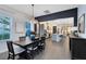 Open-concept dining area featuring an elegant chandelier, seamless transition into a modern kitchen, and stylish decor at 6665 Bridgman St, Orlando, FL 32827