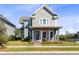 Charming two-story home with a covered front porch, well-manicured lawn, and mature landscaping at 6665 Bridgman St, Orlando, FL 32827