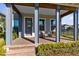 Cozy front porch with comfortable seating, creating an inviting entrance with meticulously landscaped garden in view at 6665 Bridgman St, Orlando, FL 32827