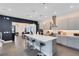 Bright kitchen featuring an expansive island with bar seating, pendant lighting, and modern cabinetry at 6665 Bridgman St, Orlando, FL 32827