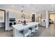 Modern kitchen featuring stainless steel appliances, a large center island with bar seating, and stylish pendant lighting at 6665 Bridgman St, Orlando, FL 32827