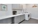 Well-equipped laundry room with a sink, cabinets, and modern washer/dryer at 6665 Bridgman St, Orlando, FL 32827