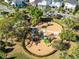 Aerial view of a community playground with slides and climbing structures nestled in green trees at 6665 Bridgman St, Orlando, FL 32827