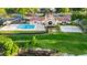 Aerial view of clubhouse, pool, volleyball court, and playground with lush landscaping at 7455 Sparkling Lake Rd, Orlando, FL 32819