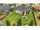 Aerial view of the home with a large backyard, brick patio, hot tub, and mature landscaping at 7455 Sparkling Lake Rd, Orlando, FL 32819