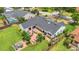 Aerial view of the home's backyard showcasing a brick patio with a dining area and hot tub at 7455 Sparkling Lake Rd, Orlando, FL 32819