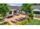 Lush backyard with a brick patio, lounge chairs, dining area, and mature landscaping at 7455 Sparkling Lake Rd, Orlando, FL 32819