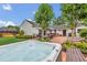 Relax in the backyard's hot tub with brick-paved patio, lush landscaping, and outdoor seating at 7455 Sparkling Lake Rd, Orlando, FL 32819