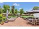Spacious backyard featuring a dining area, lounge chairs, and a hot tub at 7455 Sparkling Lake Rd, Orlando, FL 32819