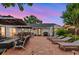 Inviting backyard with patio, lounge chairs, fire pit, and plenty of seating at 7455 Sparkling Lake Rd, Orlando, FL 32819
