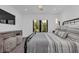 Modern bedroom featuring accent lamps, a black metal bed frame, and a wall mounted tv at 7455 Sparkling Lake Rd, Orlando, FL 32819