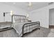 Neutral bedroom with black metal bed, contemporary side tables, and stylish decor at 7455 Sparkling Lake Rd, Orlando, FL 32819