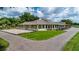 Spacious community clubhouse featuring large windows, outdoor seating, and manicured grounds at 7455 Sparkling Lake Rd, Orlando, FL 32819