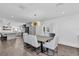 Bright dining area open to the kitchen featuring wood floors and modern chandelier at 7455 Sparkling Lake Rd, Orlando, FL 32819