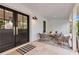Cozy front porch featuring double doors, comfortable seating, and stylish decor for relaxing outdoors at 7455 Sparkling Lake Rd, Orlando, FL 32819