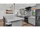 Stylish kitchen featuring gray cabinets, a large island with seating, and stainless steel appliances at 7455 Sparkling Lake Rd, Orlando, FL 32819