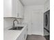 Clean kitchenette featuring stainless steel appliances, white cabinets and modern faucet at 7455 Sparkling Lake Rd, Orlando, FL 32819