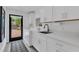 Bright laundry room with modern appliances and countertops, plus access to the patio at 7455 Sparkling Lake Rd, Orlando, FL 32819
