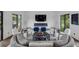 Cozy living room featuring a modern fireplace, comfortable seating, and access to outdoor patio at 7455 Sparkling Lake Rd, Orlando, FL 32819