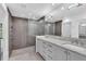 Main bathroom with a modern walk-in shower, dual sinks, and sleek gray cabinetry at 7455 Sparkling Lake Rd, Orlando, FL 32819