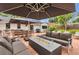 Enjoy the outdoor patio with comfortable seating, an umbrella and a modern fire pit at 7455 Sparkling Lake Rd, Orlando, FL 32819