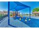 Community playground with colorful equipment, shaded by a blue canopy for safe play at 7455 Sparkling Lake Rd, Orlando, FL 32819