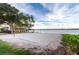 Lakeside community volleyball court with soft sand, gazebo, and scenic water views at 7455 Sparkling Lake Rd, Orlando, FL 32819