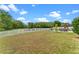 Large backyard with patio, playground, and white picket fence bordering a pond at 820 Timber Isle Dr, Orlando, FL 32828