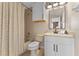 Full bathroom features a white vanity, cabinet, and a shower/tub combo at 820 Timber Isle Dr, Orlando, FL 32828