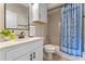 Bright bathroom features blue patterned shower curtain, white vanity, and stylish accents at 820 Timber Isle Dr, Orlando, FL 32828