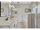Elegant bathroom with dual vanities, a soaking tub, and a glass-enclosed shower at 820 Timber Isle Dr, Orlando, FL 32828