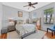 Bright bedroom with wood floors, neutral walls, and natural light through the windows at 820 Timber Isle Dr, Orlando, FL 32828