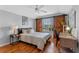 Bedroom features a sliding barn door over the window and modern décor at 820 Timber Isle Dr, Orlando, FL 32828