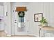 Inviting entryway with a glass door, wreath, and decorative table at 820 Timber Isle Dr, Orlando, FL 32828
