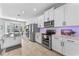 Bright, modern kitchen with stainless steel appliances and ample white cabinetry at 820 Timber Isle Dr, Orlando, FL 32828