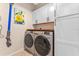 Functional laundry room with modern machines and built-in storage at 820 Timber Isle Dr, Orlando, FL 32828