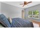 Bright main bedroom featuring wood floors, neutral paint, and a large window at 820 Timber Isle Dr, Orlando, FL 32828